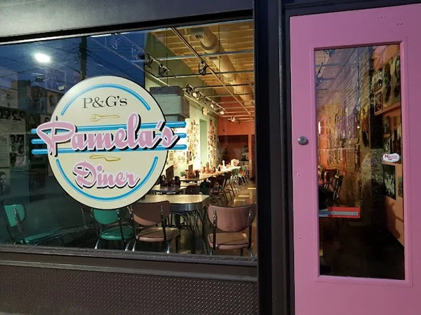 Pink entrance door and window at Pamela’s Strip District diner