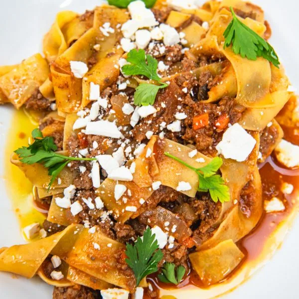 Wide pasta with sauce and cheese at Bar Pazzo