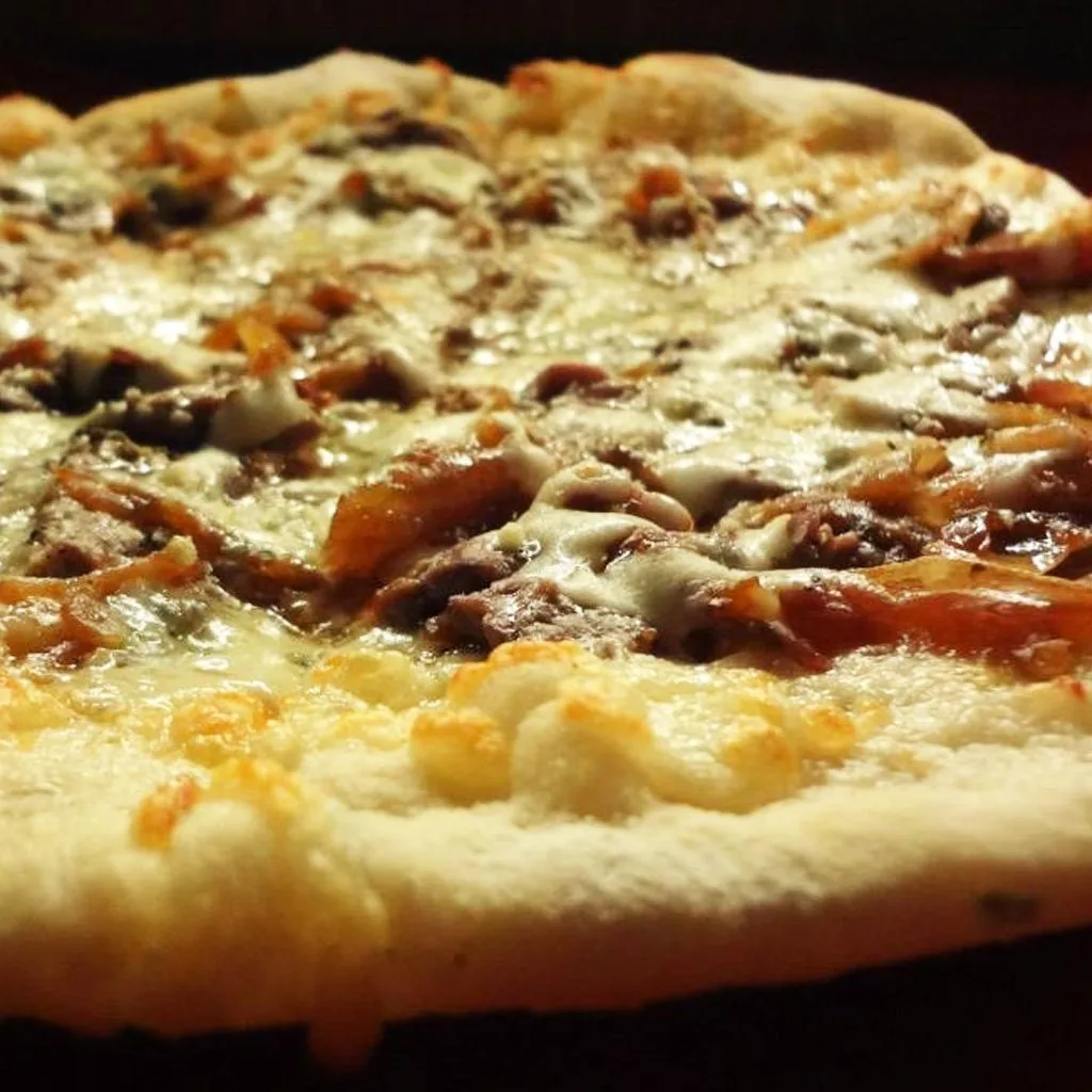 Hearth-fired pizza shown by Judy’s On Cherry