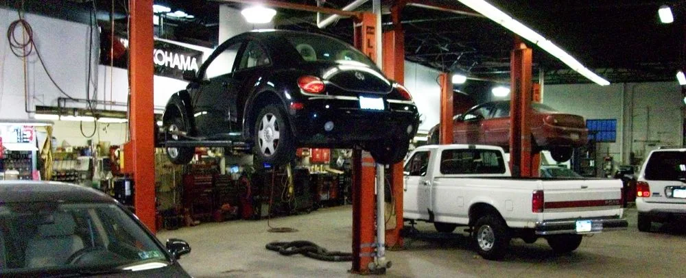 Vehicle on a lift inside an automotive service bay