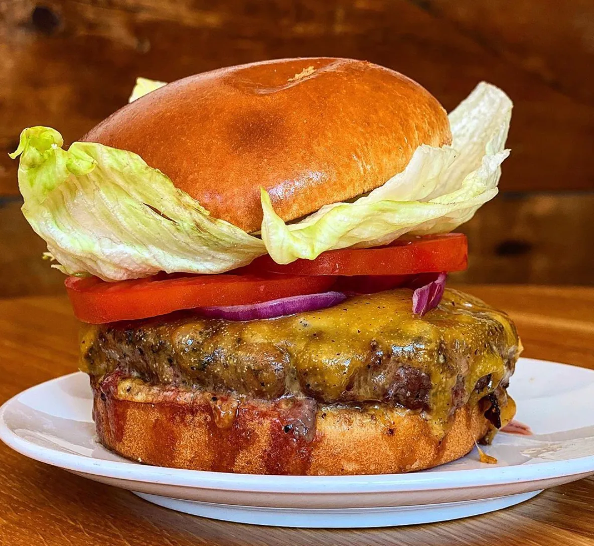 Burger with lettuce, tomato and cheese at Union and Finch