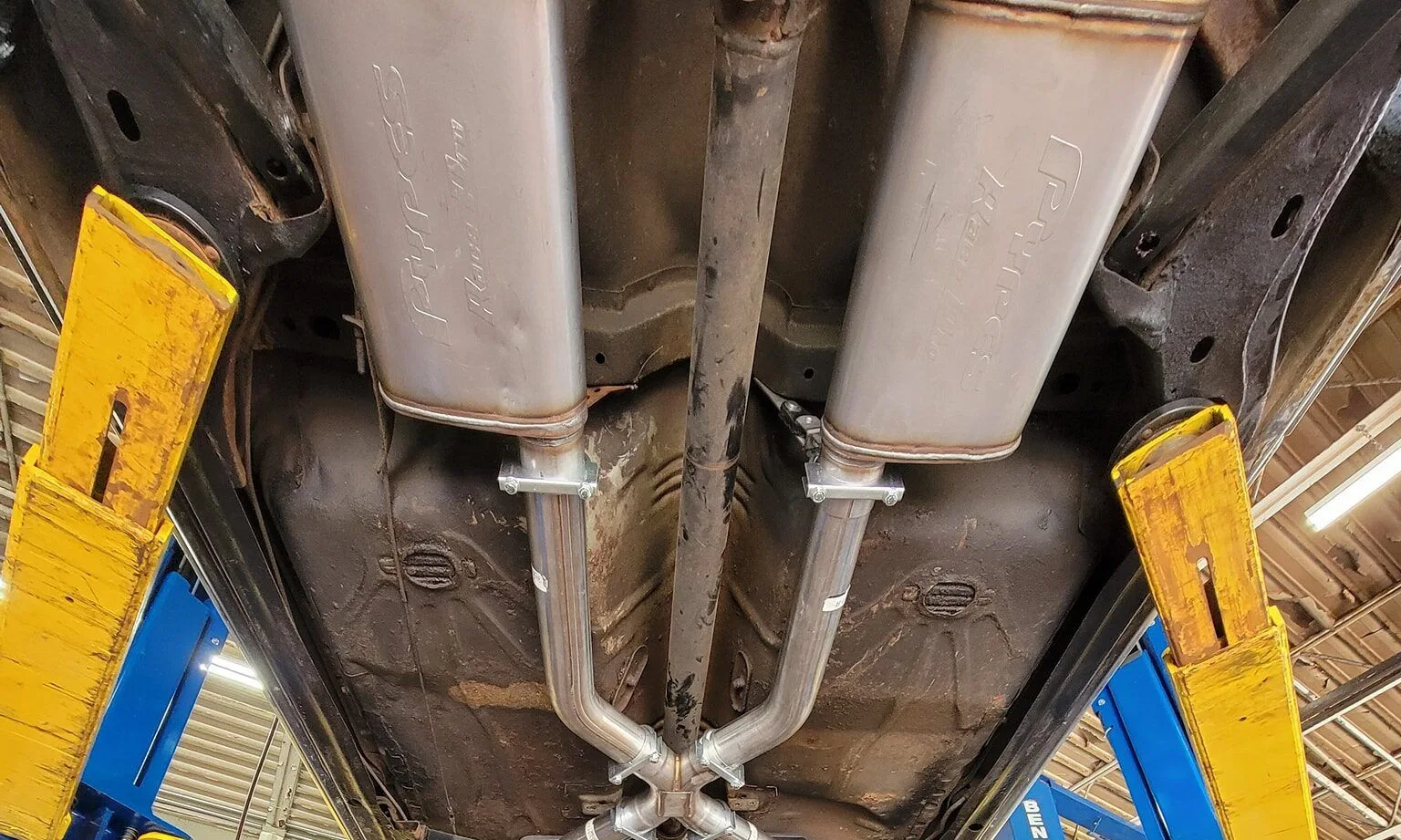 Custom exhaust pipes beneath a vehicle