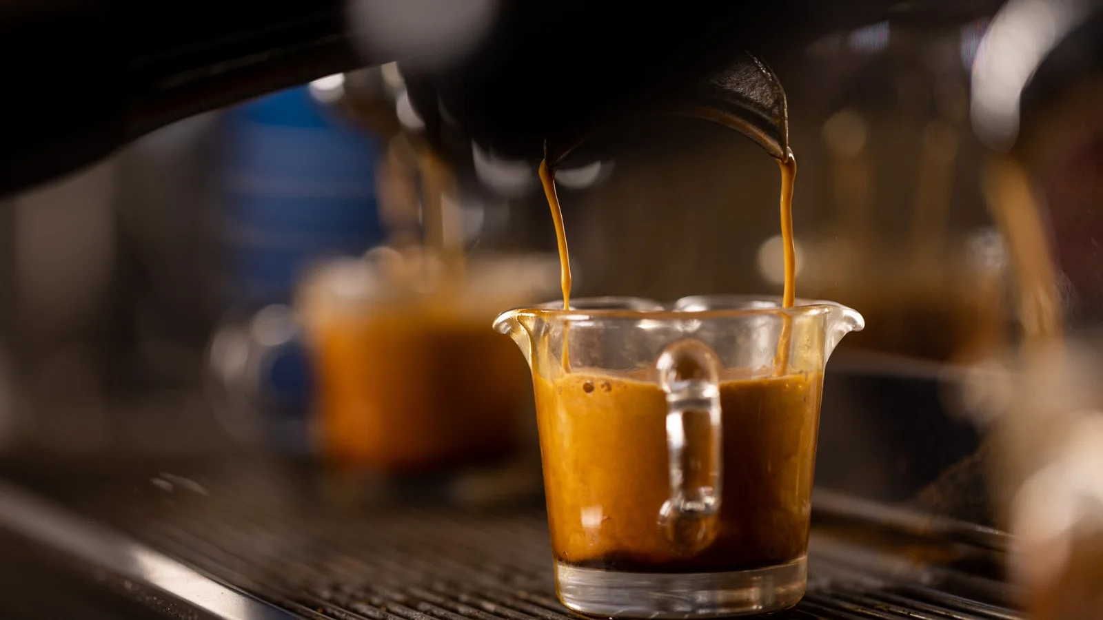 Espresso flowing from a machine into a glass