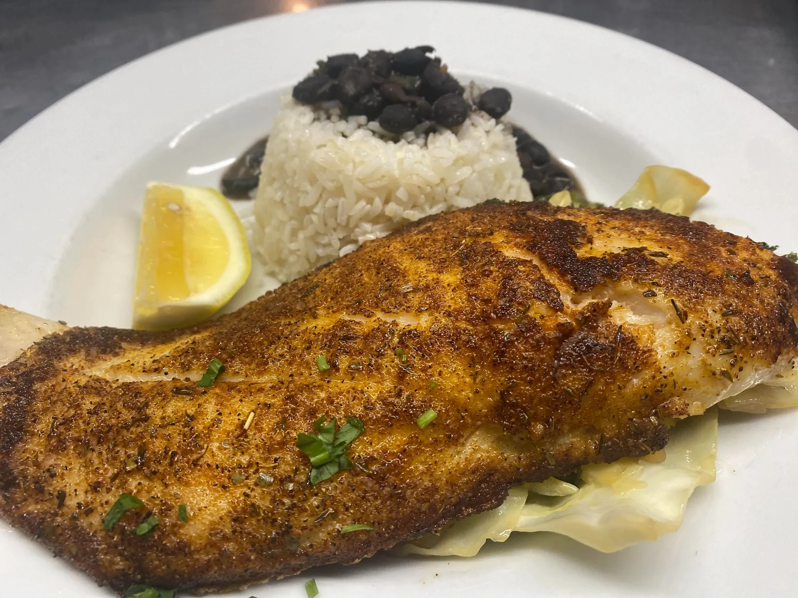 Seasoned fish entrée with rice and vegetables
