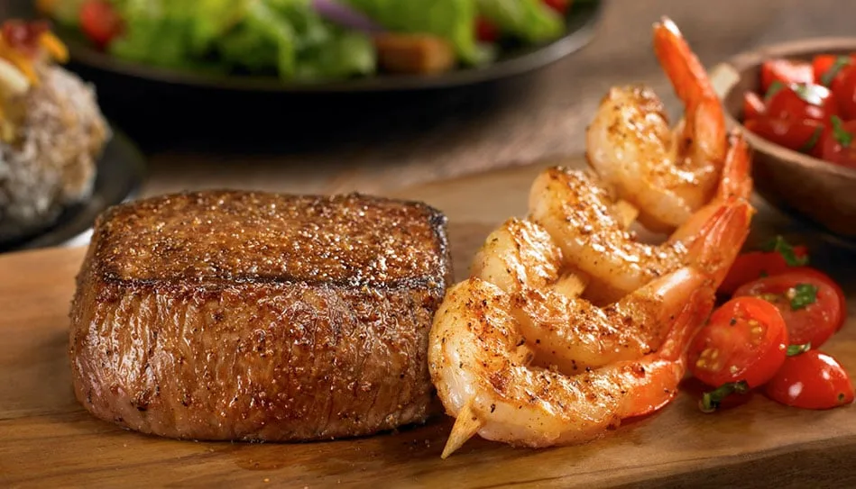 Steak with shrimp on a serving board at Cooper's