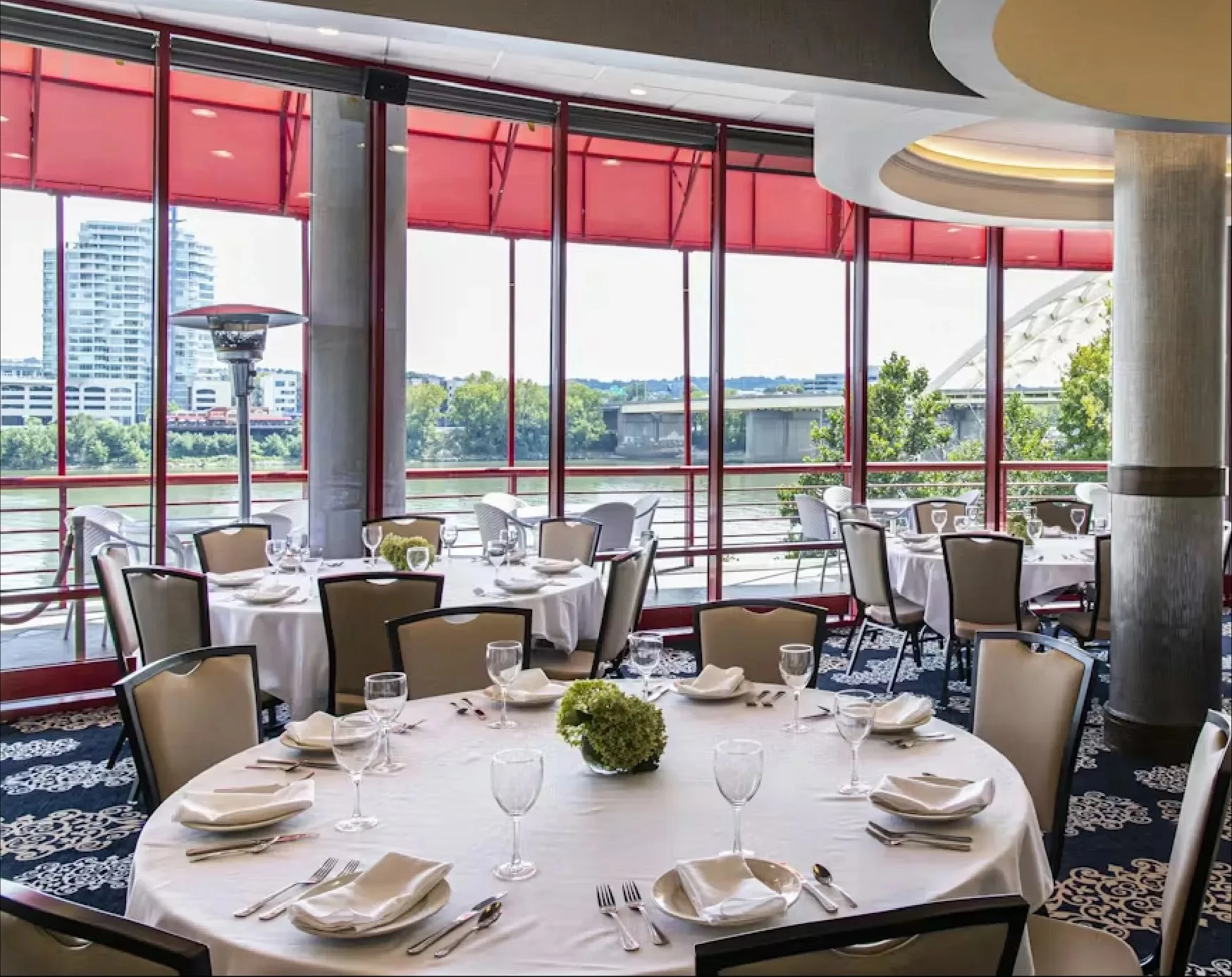 Dining room set for dinner with river views