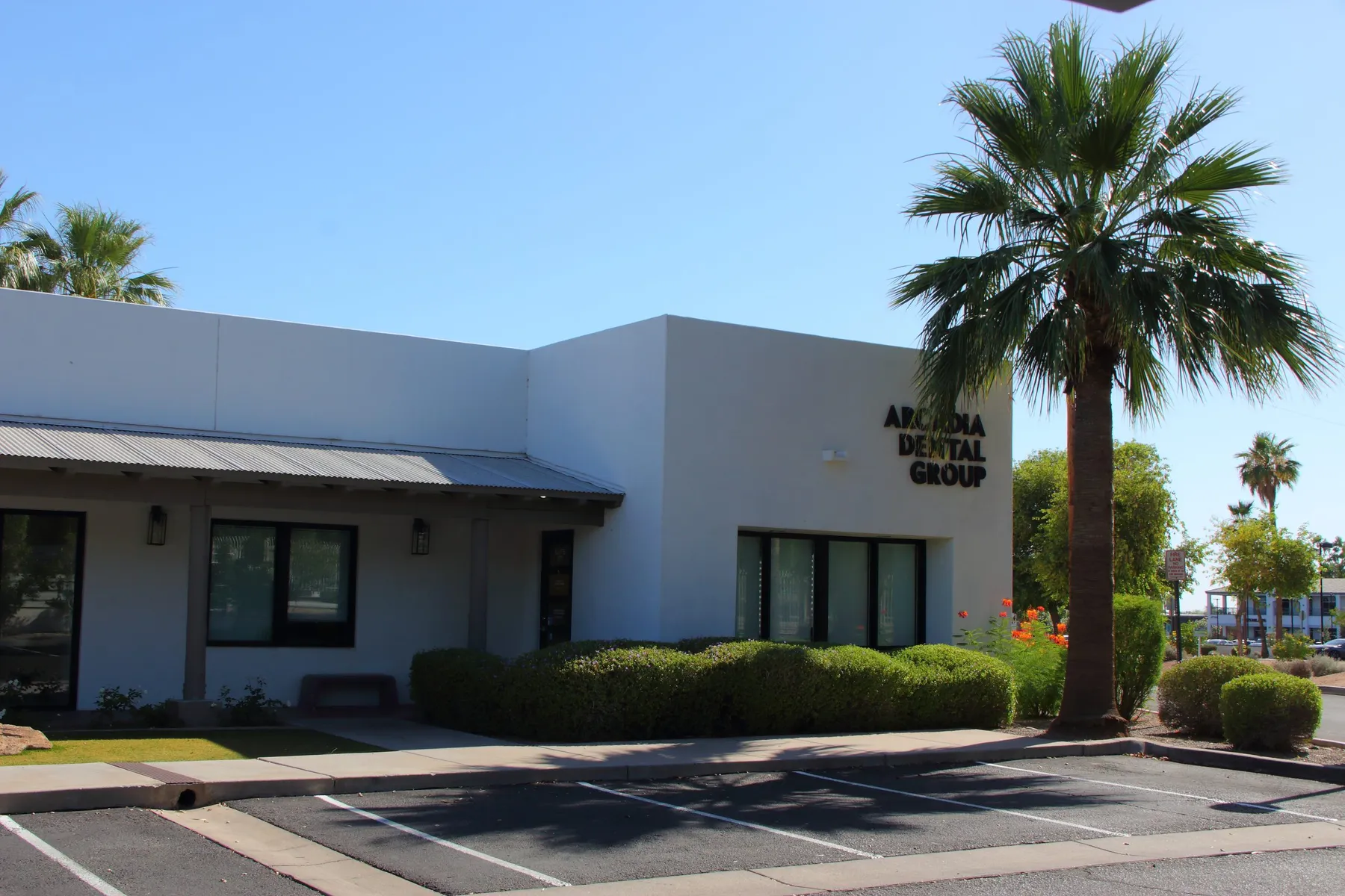 The Arcadia Dental Group building with a palm tree out front