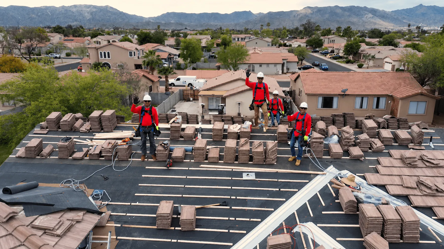 A Lyons Roofing crew laying tile on a Phoenix-area roof